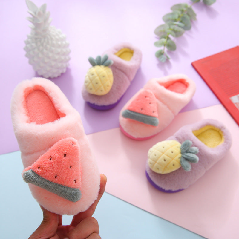 Plush slippers shaped like watermelon and pineapple on a colorful background