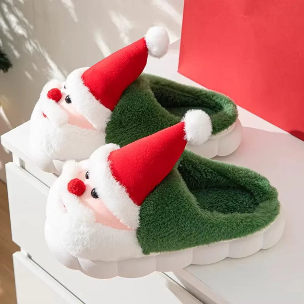 Pair of Santa Claus-themed slippers on a white surface with a red background.