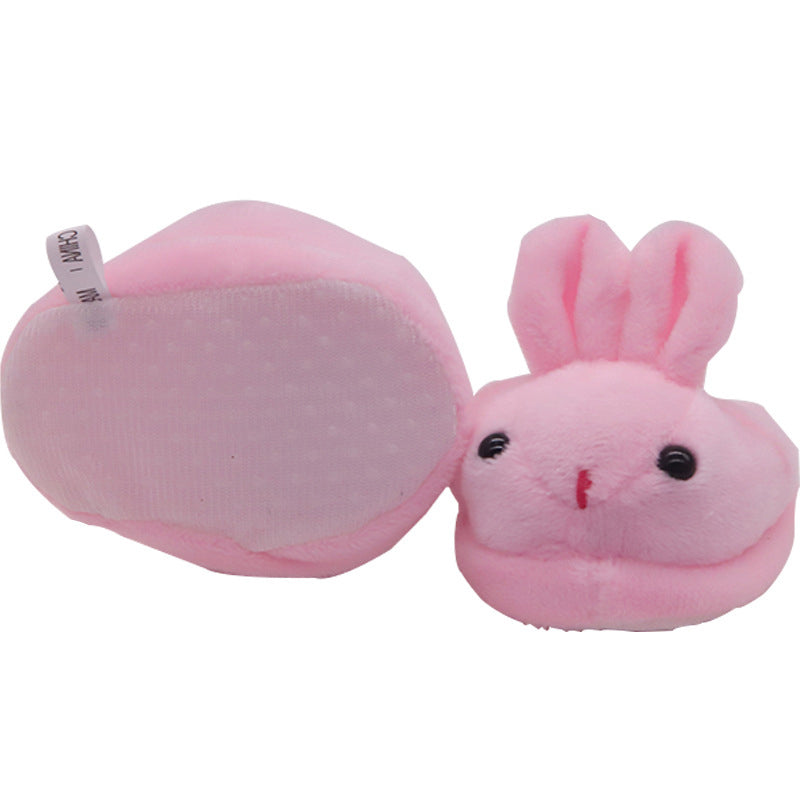 Pink plush bunny with a white background