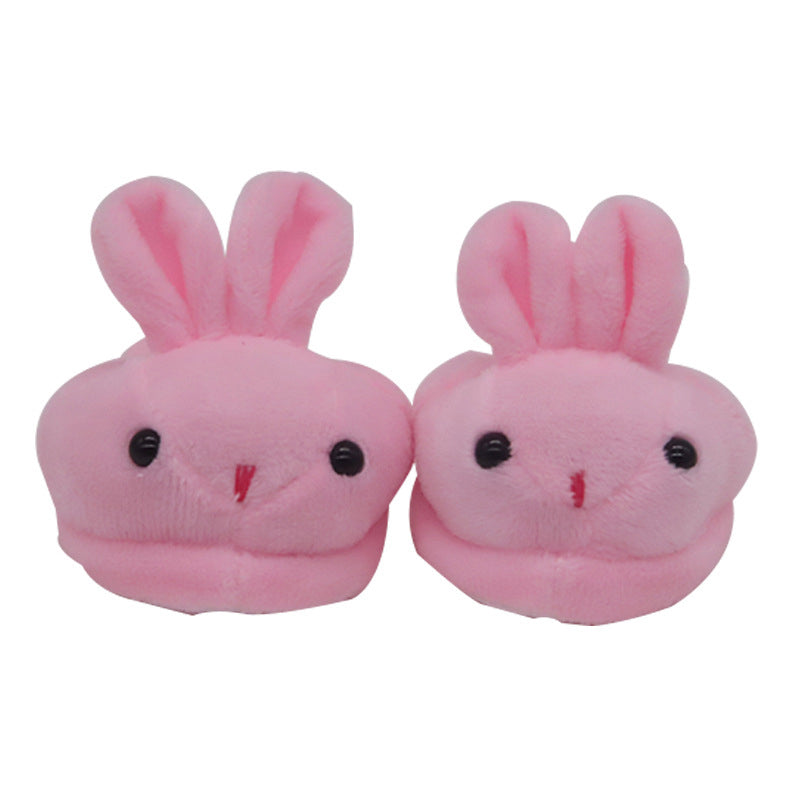Pair of pink bunny slippers on a white background