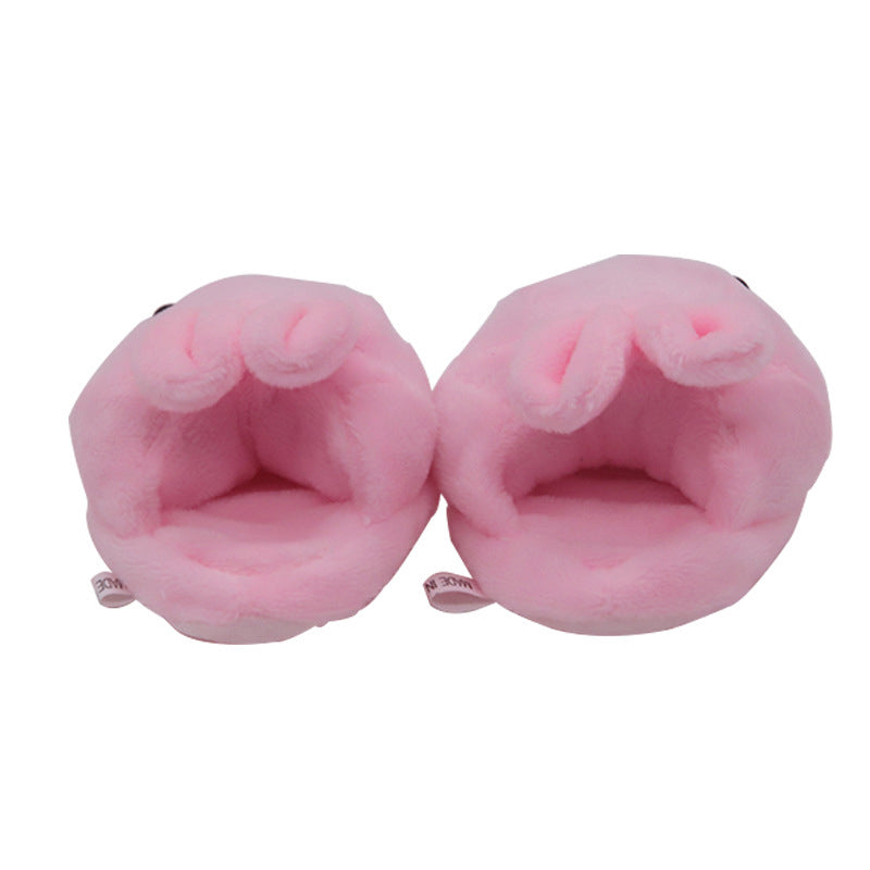 Pair of pink plush slippers on a white background