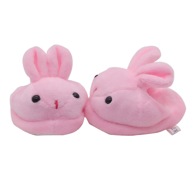 Pair of pink bunny slippers on a white background
