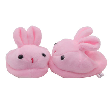 Pair of pink bunny slippers on a white background