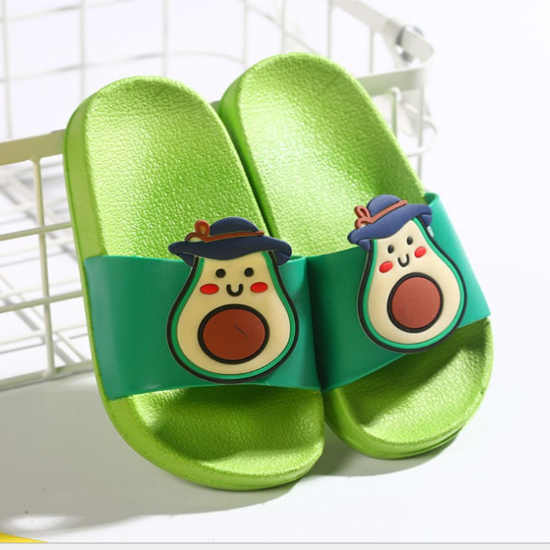 Green slippers with avocado design on a white background
