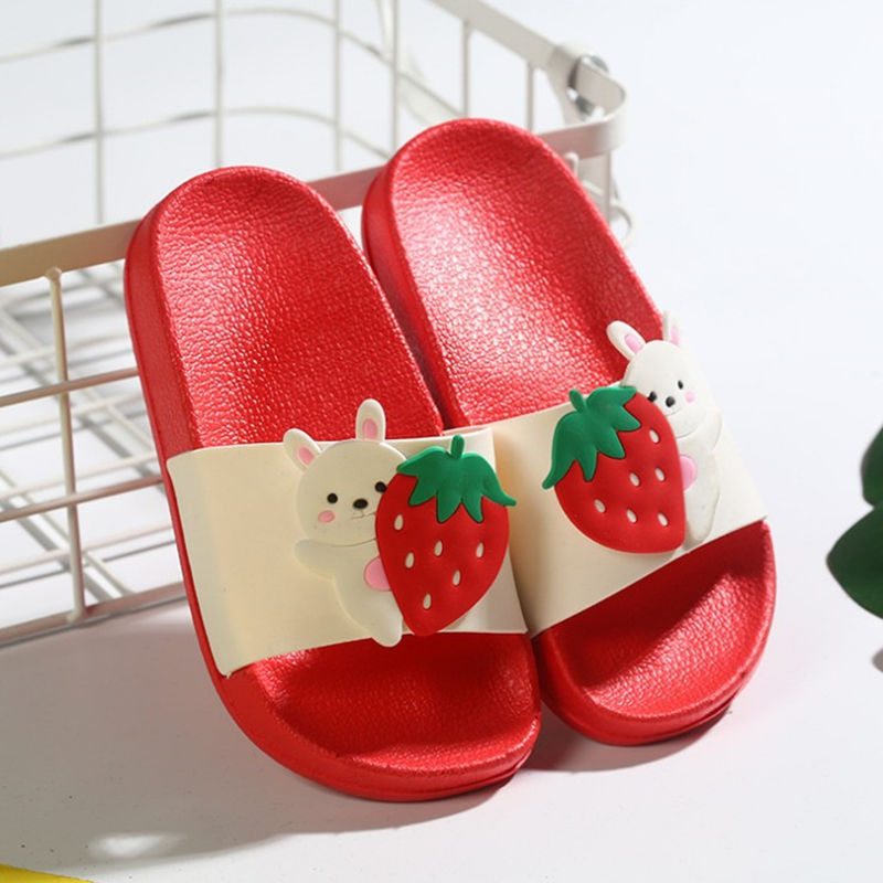 Red slippers with strawberry and bear design on a white background