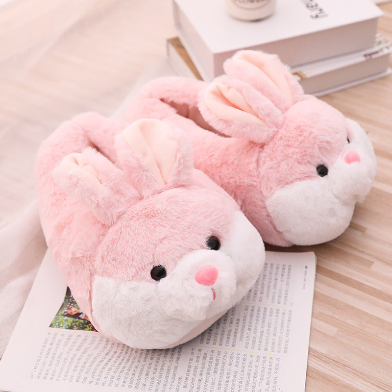 Pink rabbit slippers on a wooden surface with books in the background