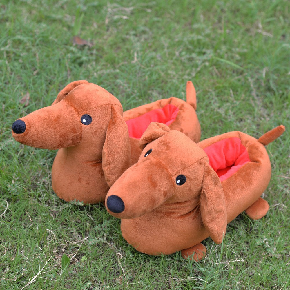 Two brown dachshund-shaped slippers on grass
