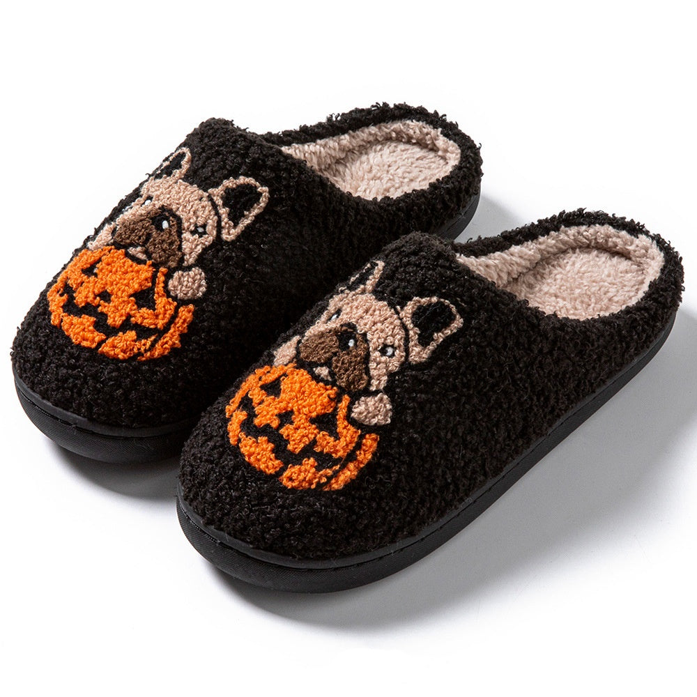 Black slippers with pug dog and pumpkin design on a white background