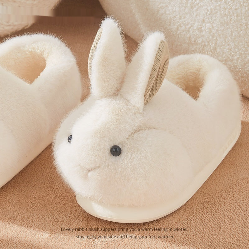 White rabbit-shaped slippers on a soft beige background