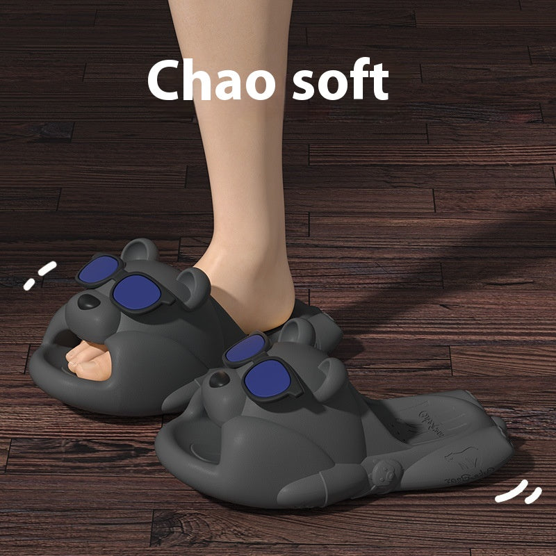 Gray animal-shaped slippers with blue pads on a wooden floor, labeled 'Chao soft'