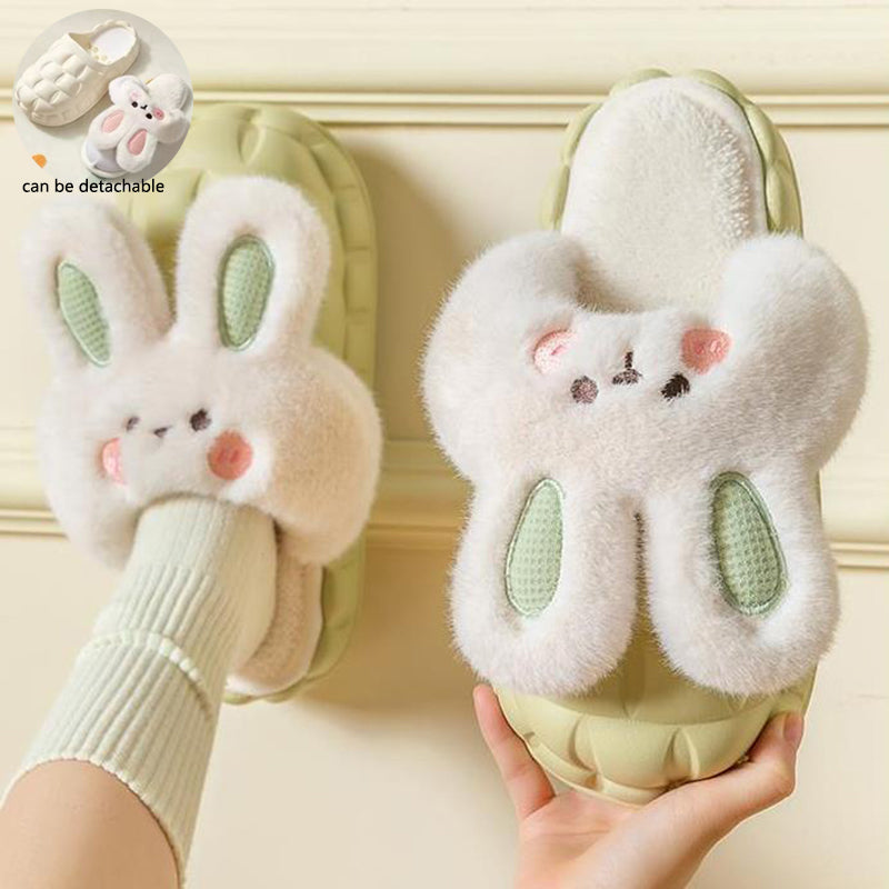 Pair of cute bunny slippers held by a person against a light background