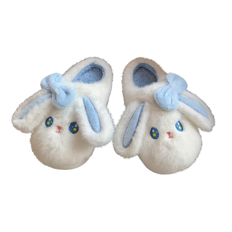 Pair of white bunny slippers with blue accents on a white background
