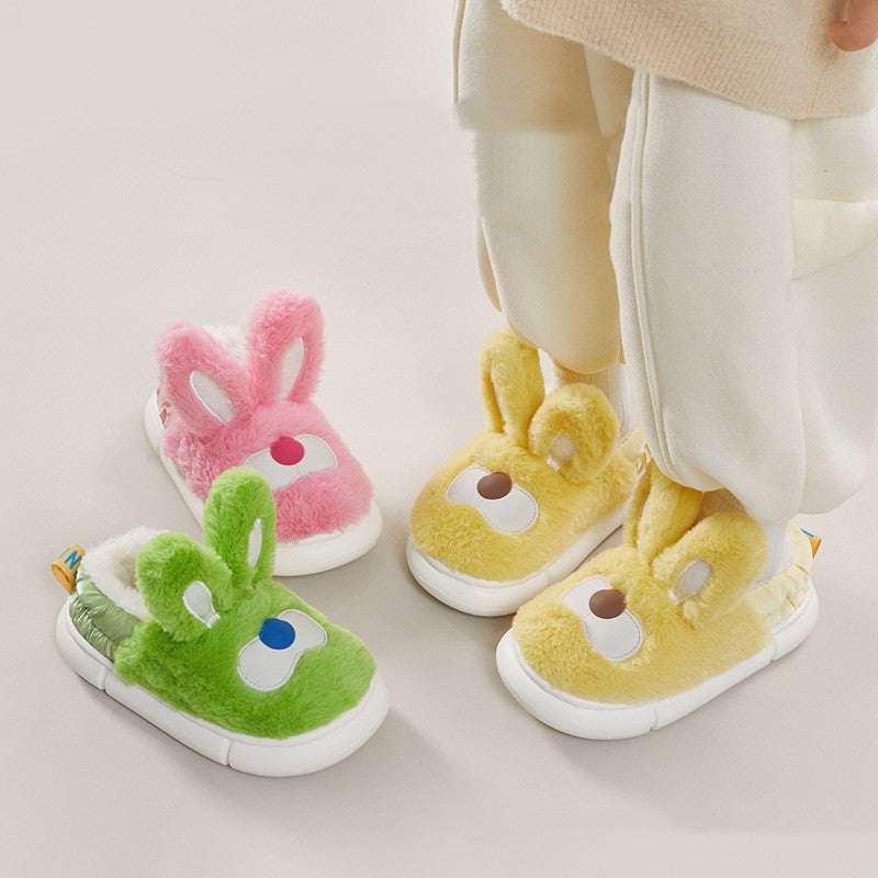 Children's Bunny and cartoon slippers in green, pink, and yellow on a light background