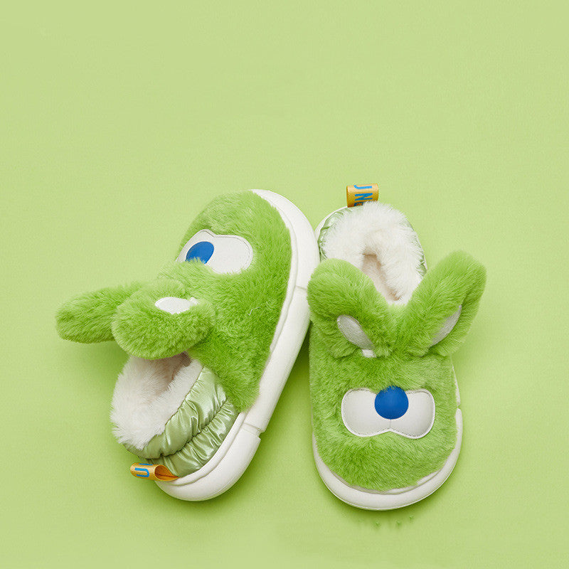 Green plush slippers with Rabbit face design on a green background