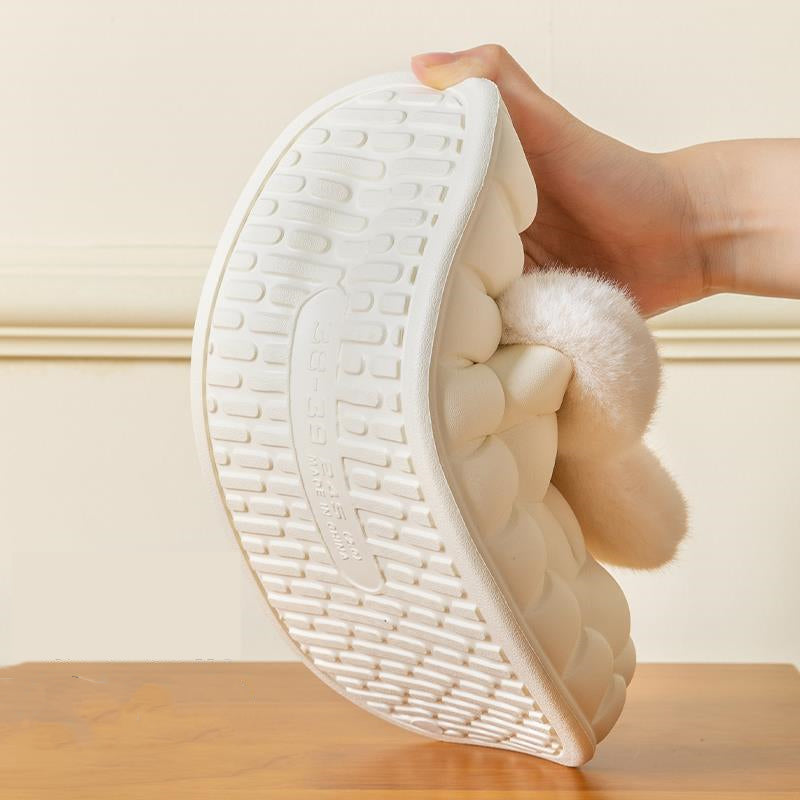 White wedge shoe with fluffy interior held by a hand on a wooden surface.