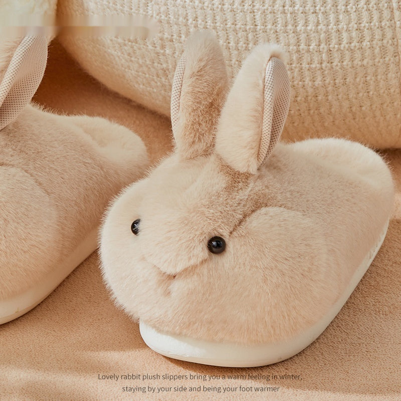 Beige rabbit-shaped plush slippers on a beige background