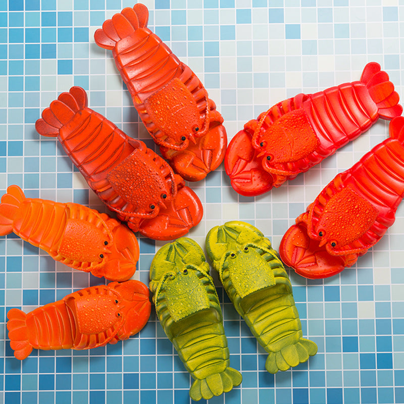 Red, orange and green lobster-shaped slippers on a blue tiled surface
