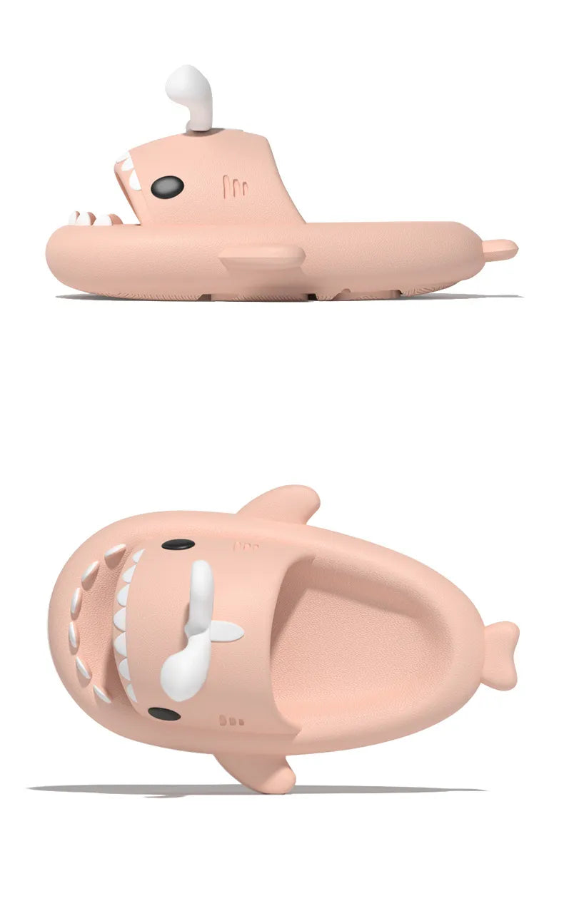 Two pink shark-shaped bath toys on a white background
