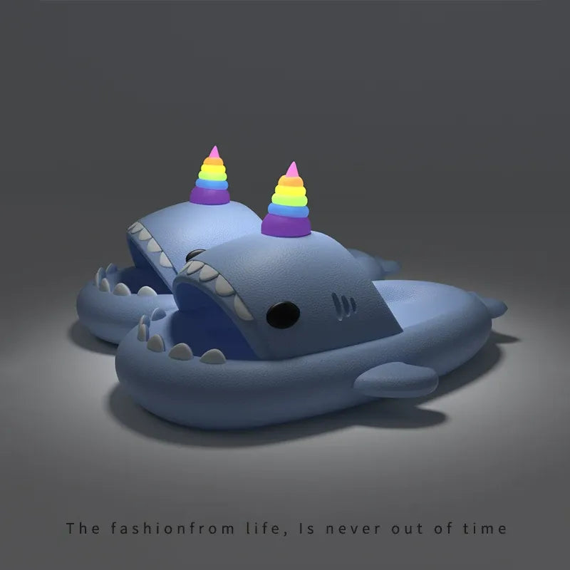 Blue shark toy with rainbow hats on a dark background