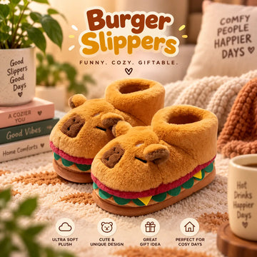 A pair of plush yellow-brown slipper shoes shaped like burgers, with embroidered eyes and noses and colorful faux lettuce and tomato layers. The image includes decorative props such as books, a mug, and cozy textiles, with large text reading 'Burger Slippers' and smaller feature callouts at the bottom.