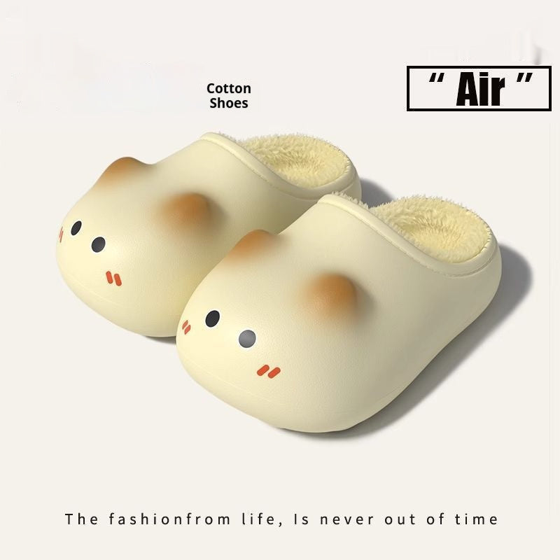 Pair of cartoonish slippers with a cute face design on a white background.