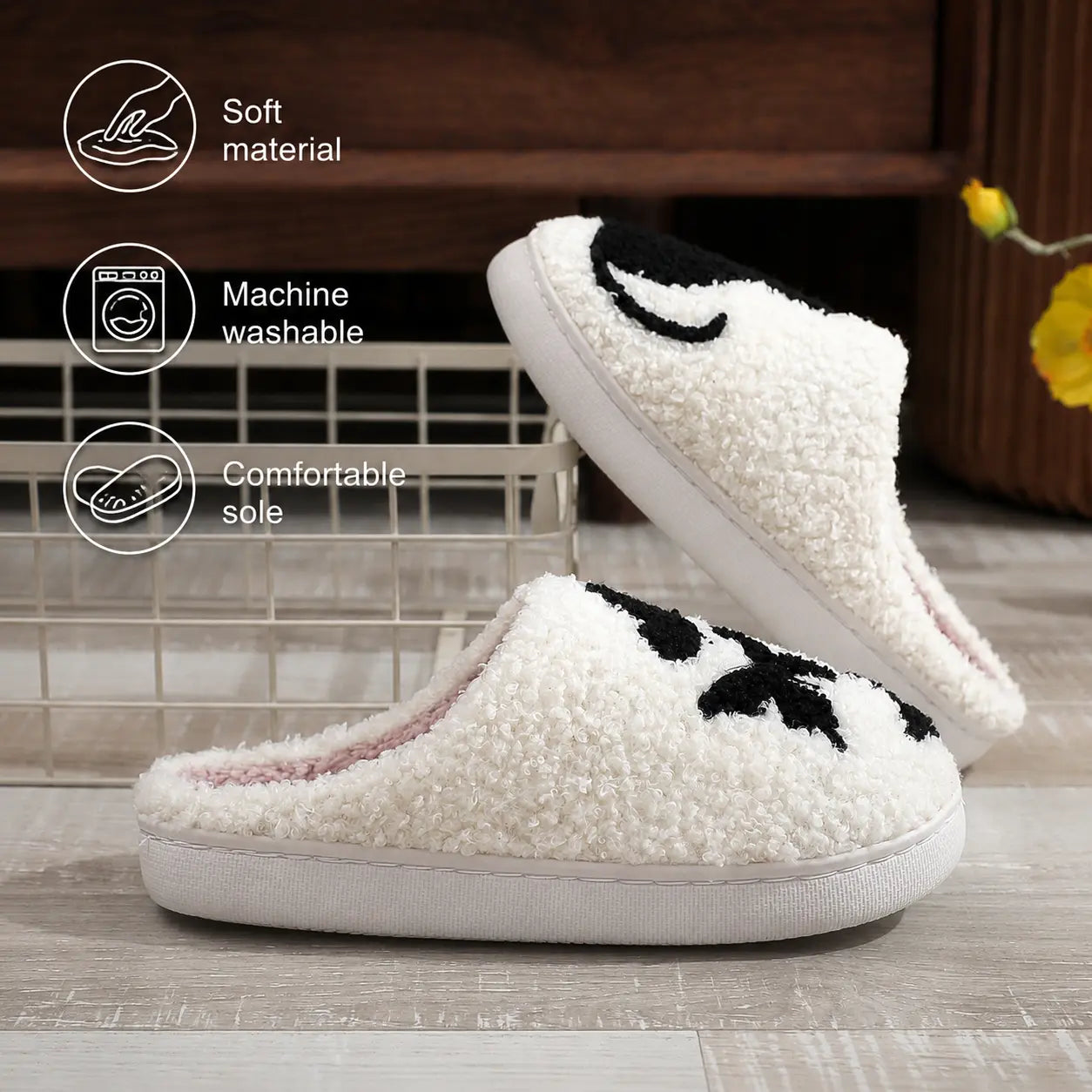 White slippers with black accents on a wooden floor, featuring icons and text about material, washability, and sole comfort.