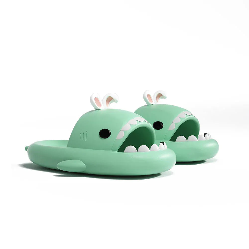 Pair of green children's sandals with animal face design on a white background