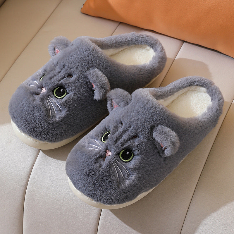 Gray cat-shaped slippers on a beige surface