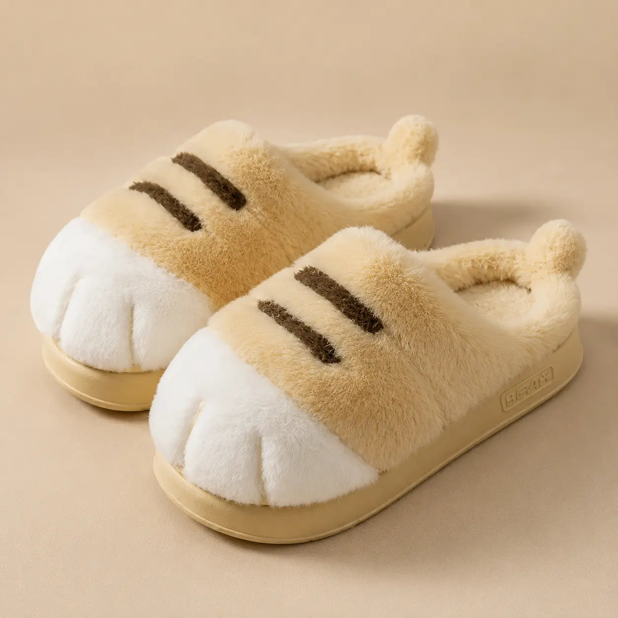 Pair of cat-themed slippers on a beige background