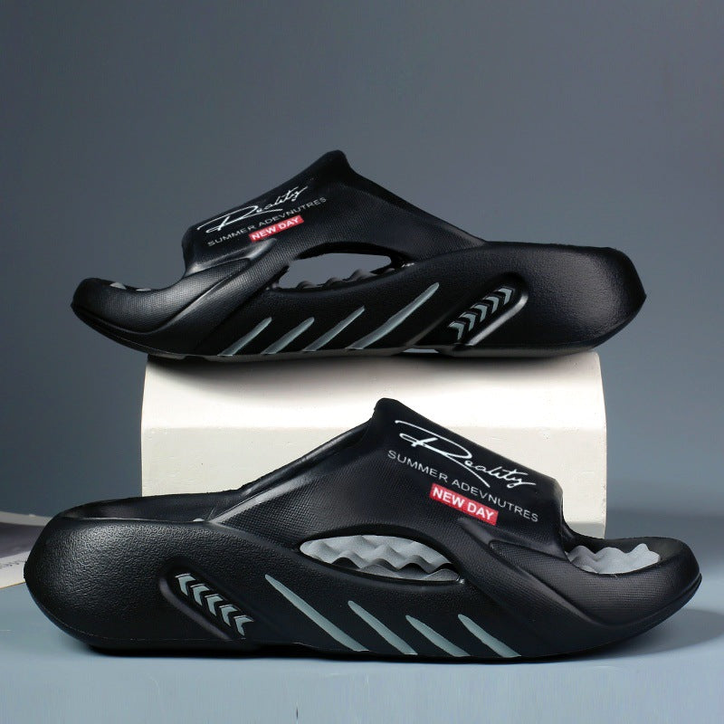 Black sandals with brand logo on a gray background