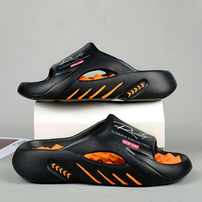 Black and orange sandals with 'New Day' branding on a gray background