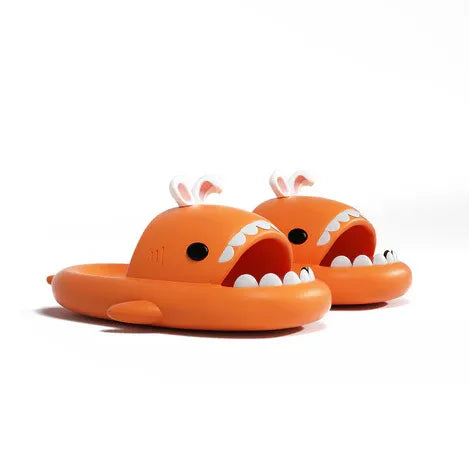 Orange shark-shaped slippers on a white background