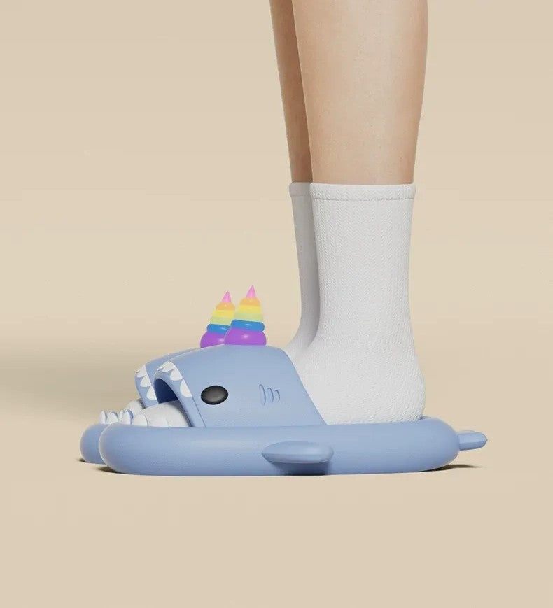 Blue sandal with unicorn design worn by a person on a beige background
