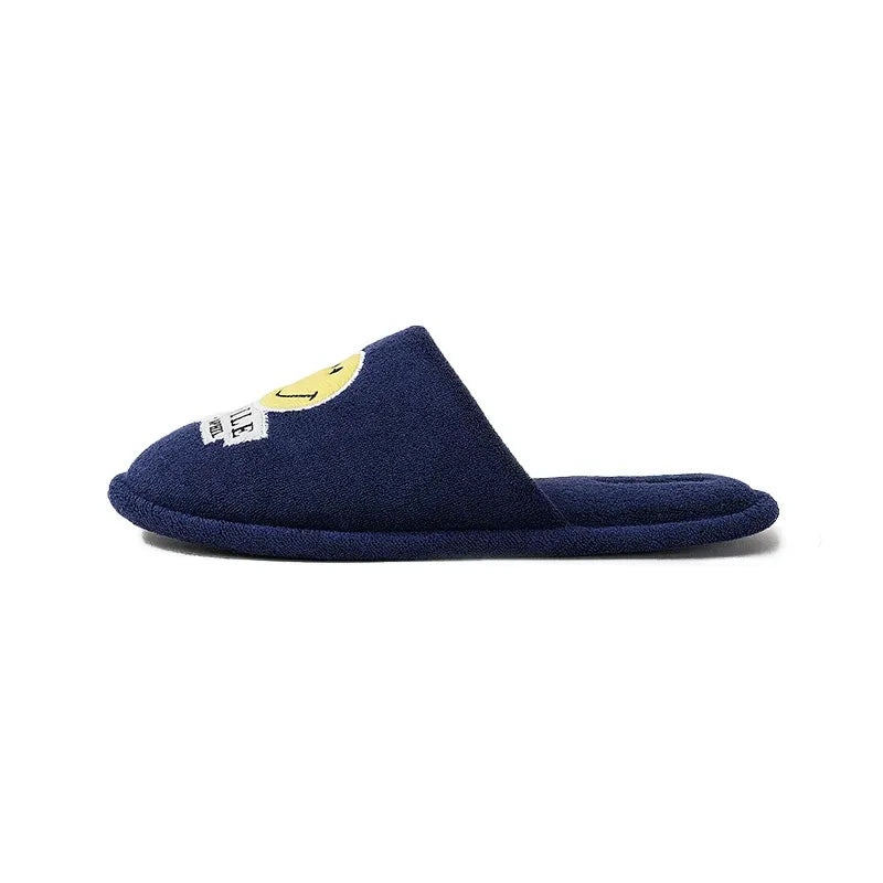 Navy blue slipper with a smiley face label on a white background