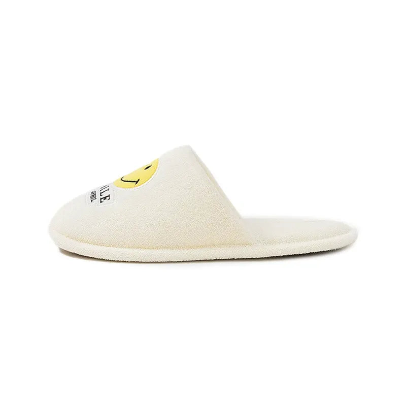 White slipper with a yellow logo on a white background