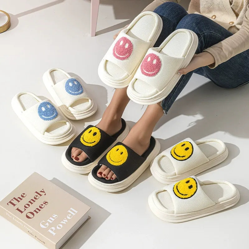 Smiley face slippers on a light surface with a book titled 'The Lonely Ones' by Carole Woll.