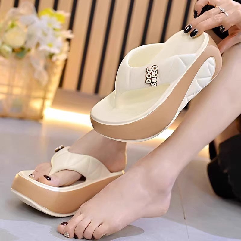 Beige sandals with a brand logo being worn by a person indoors.