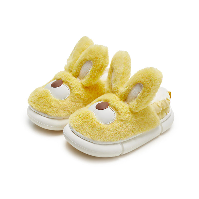 Yellow bunny slippers with white soles on a white background