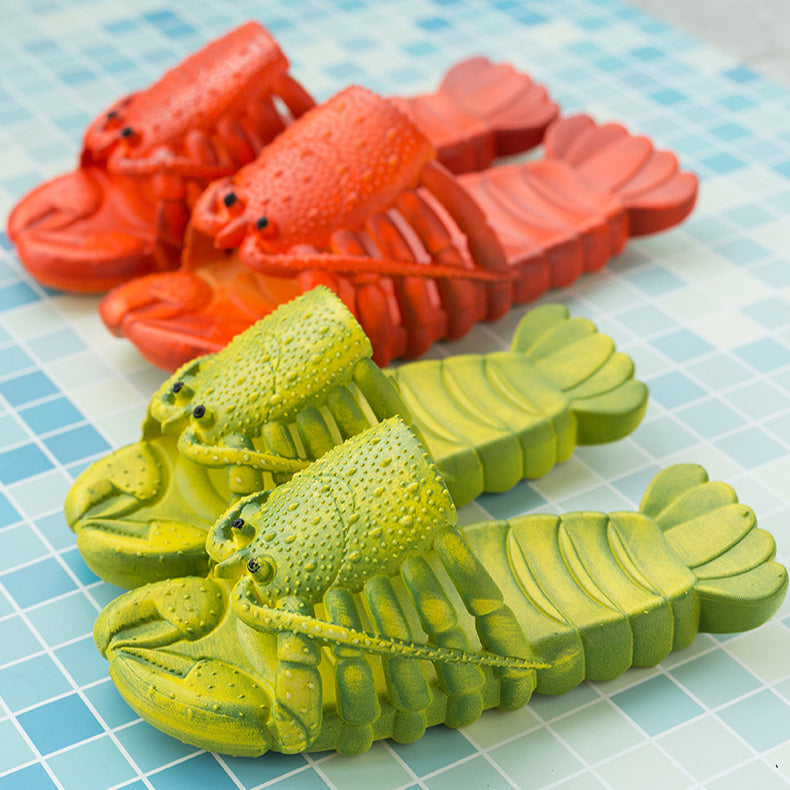 Red and green lobster-shaped slippers on a checkered surface