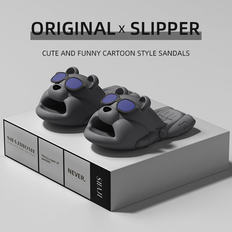 Gray slipper with blue accents on a white platform, labeled 'Original x Slipper' on a gray background.