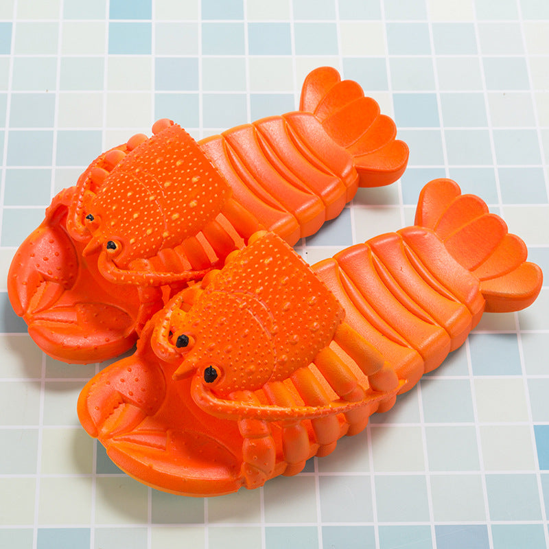  orange lobster-shaped slippers on a tiled bathroom floor.