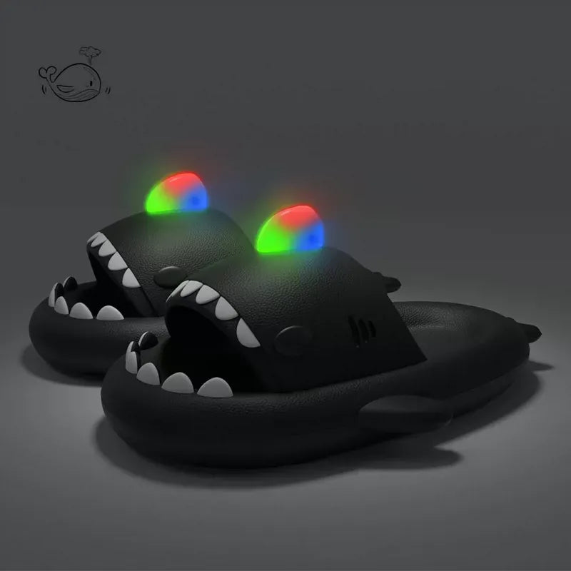 Black shark-shaped slippers with glowing eyes on a dark background