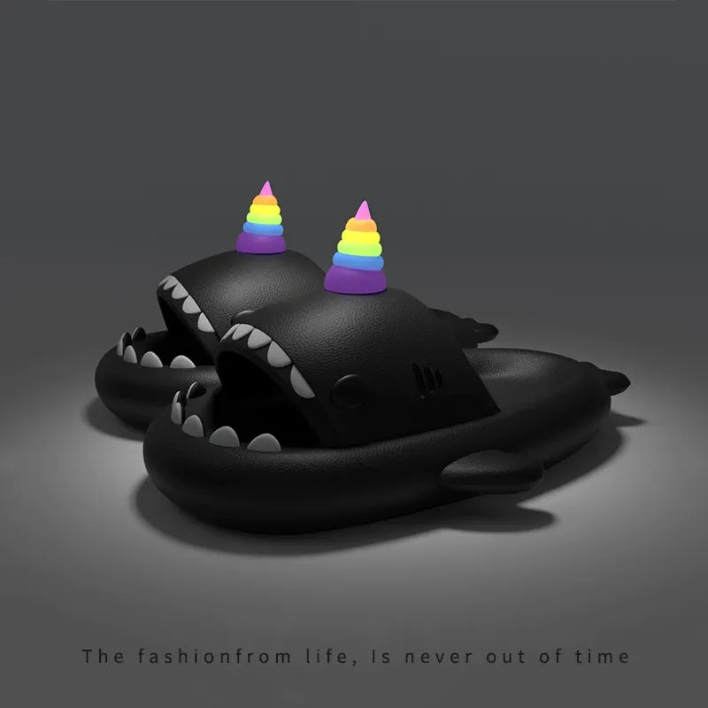 Black shark-shaped toy with rainbow hats on a dark background