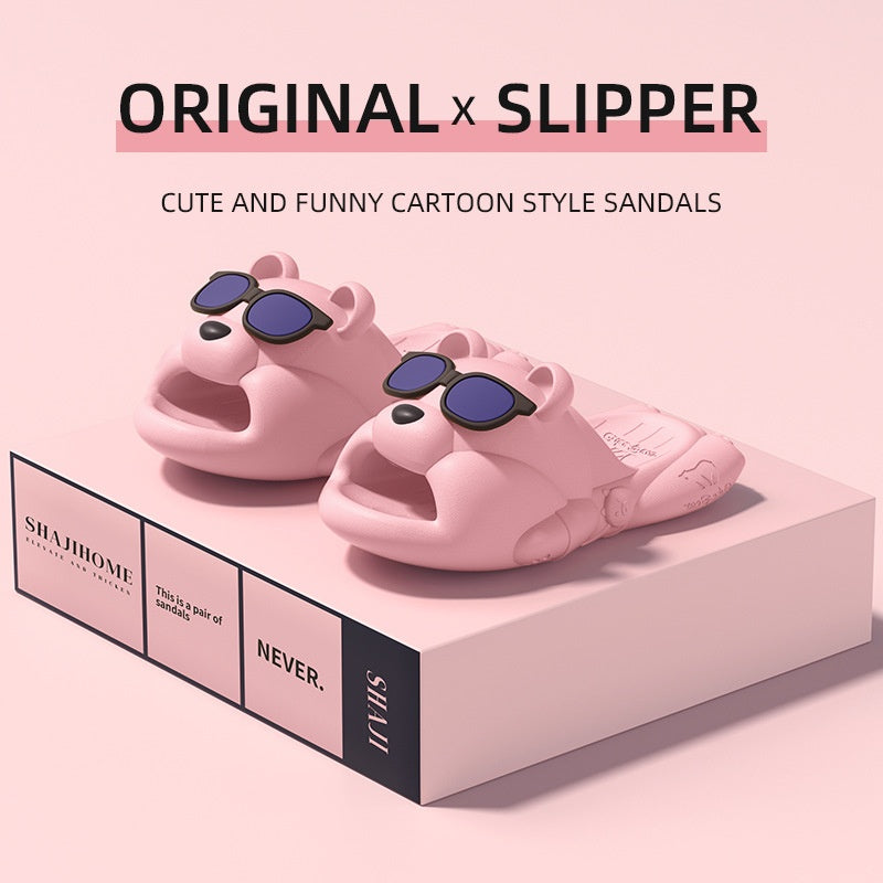 Pink Novelty animal slippers with sunglasses on a pink platform, featuring the brand 'SHAHOME'.