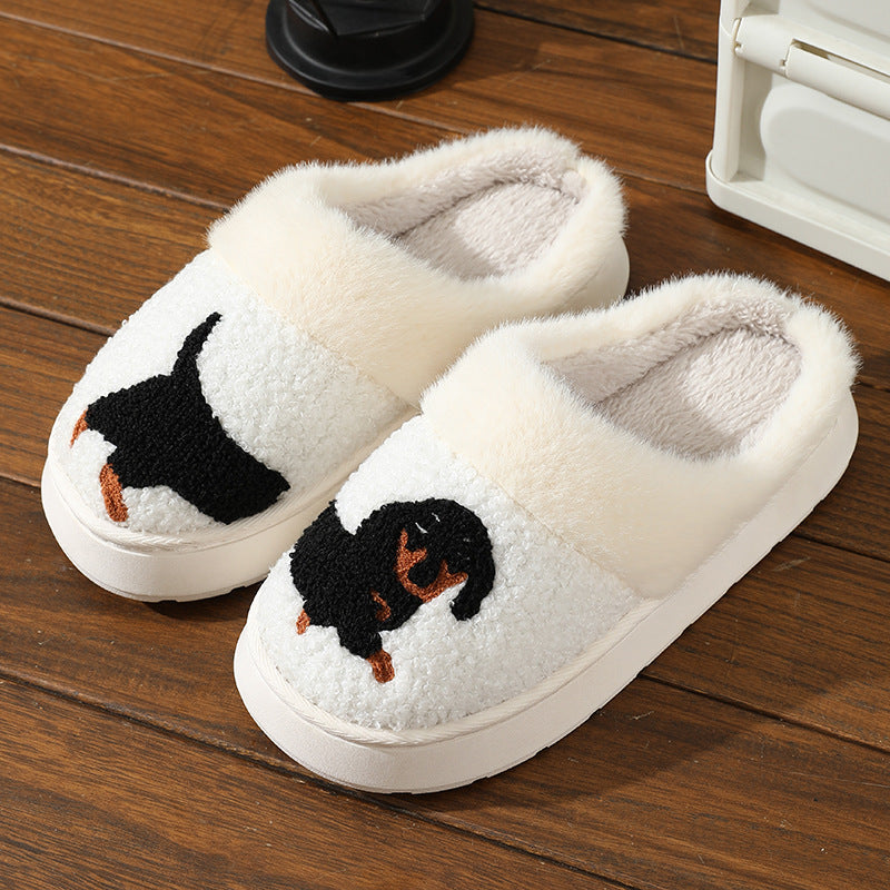 White slippers with dachshund design on a wooden floor