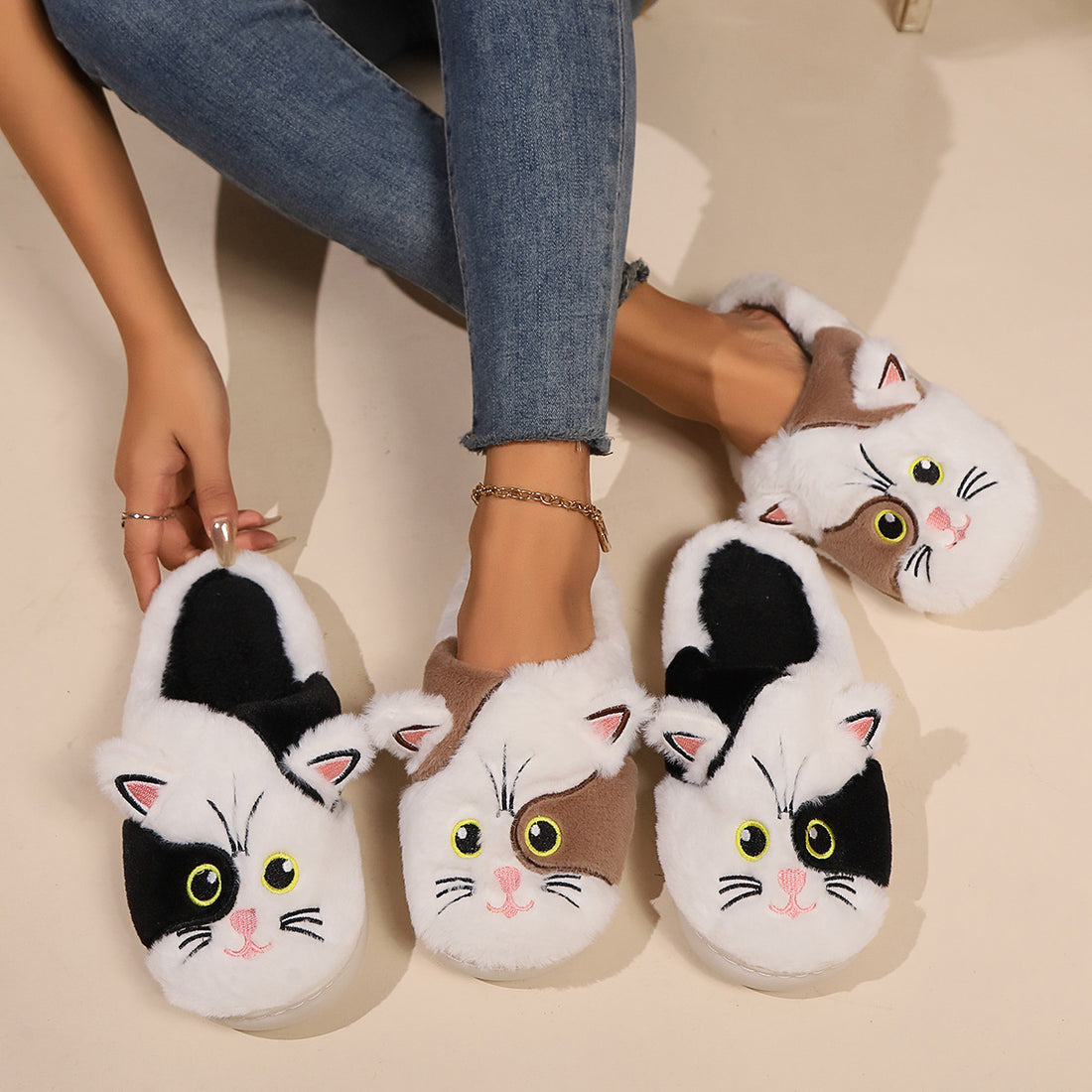 Cat-themed slippers worn by a person on a light background