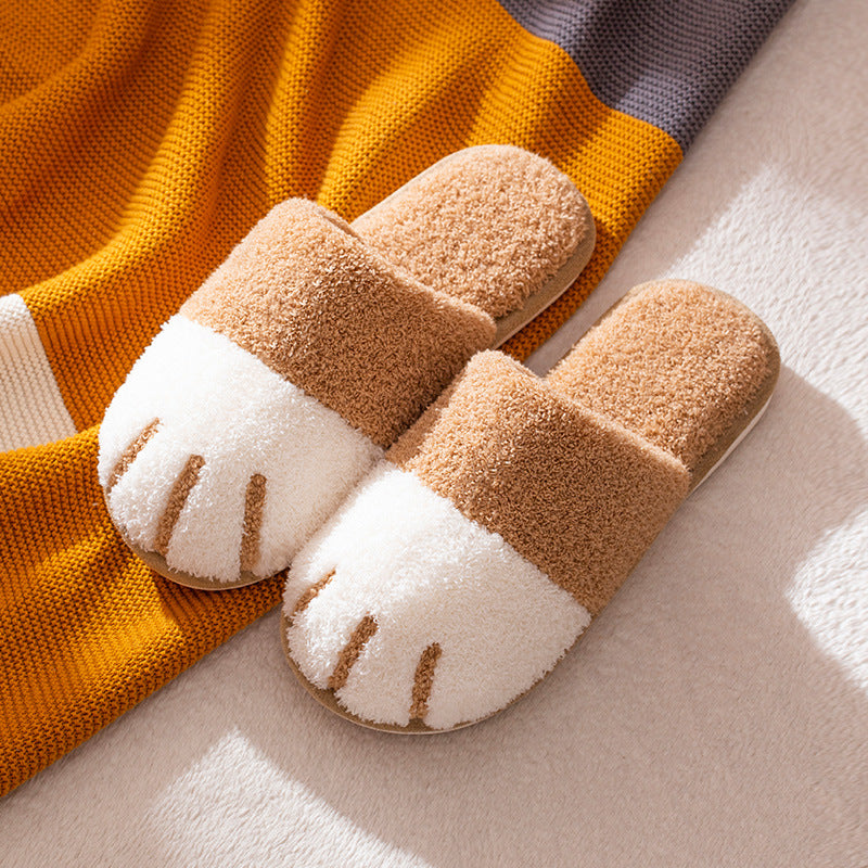 Pair of brown and white slippers on a striped fabric background