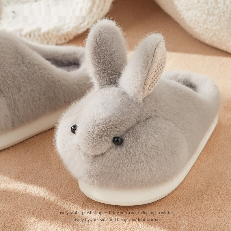 Gray rabbit-shaped plush slipper on a beige surface