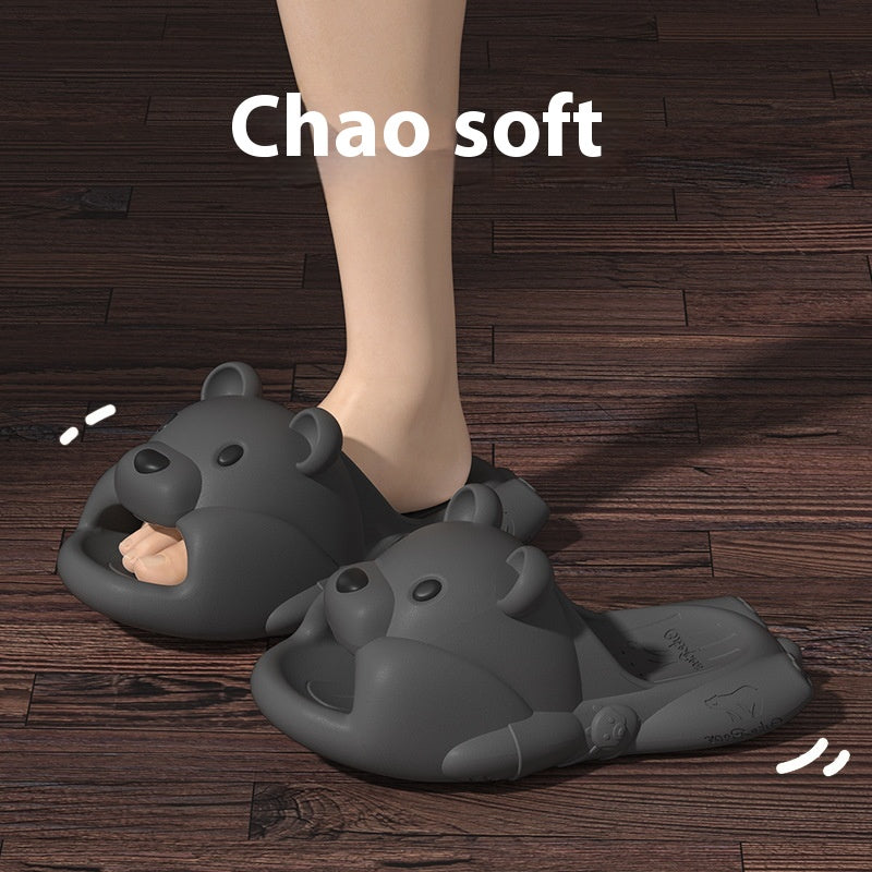 Gray bear-shaped slippers on a wooden floor with 'Chao soft' text.