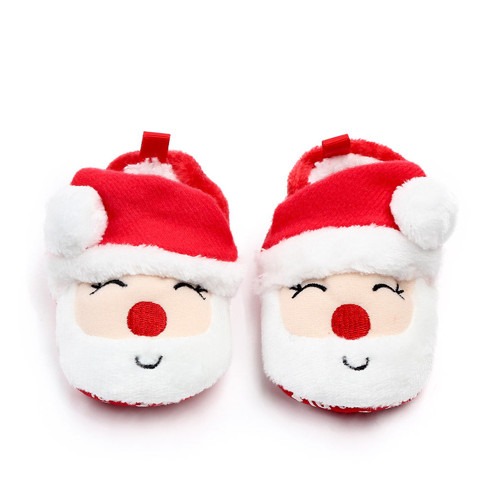 Pair of Santa Claus-themed baby shoes on a white background